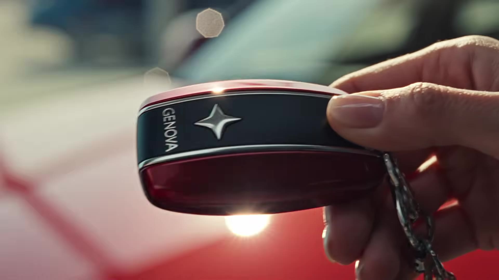 Scene 1 payoff: the sales consultant hands over the GENOVA-branded key