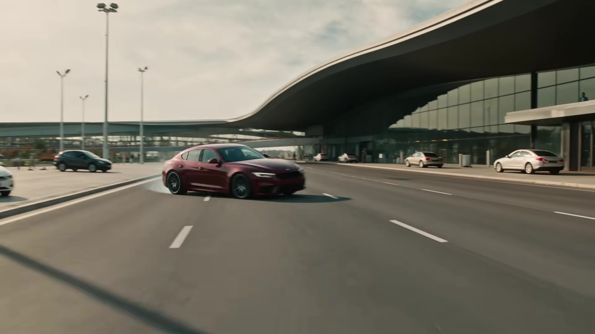 Finale: red GENOVA sedan drift-parking at the airport terminal